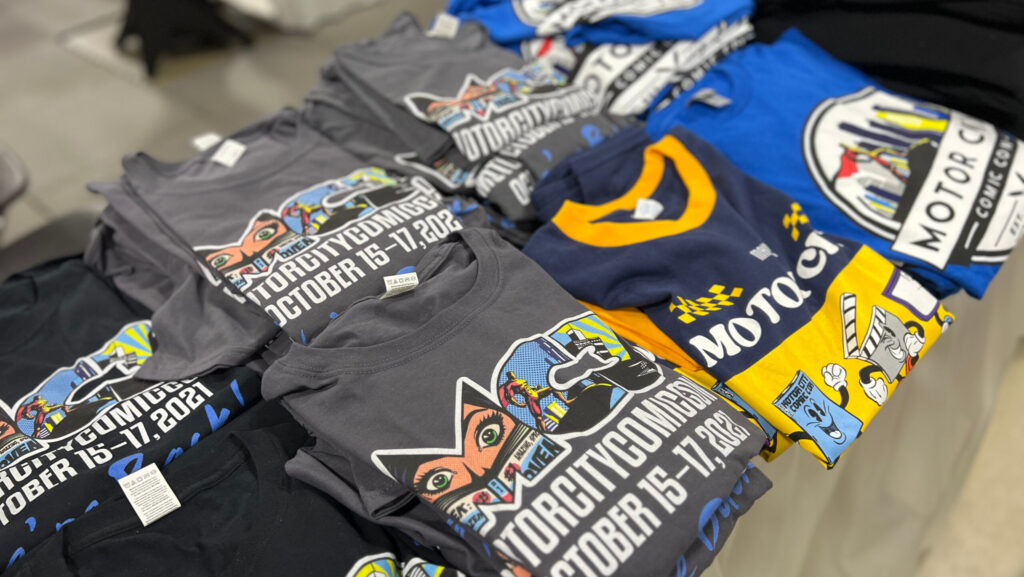 Motor City Comic Con t-shirts on display.