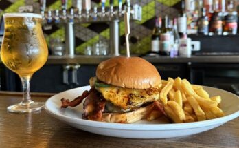 A beer and burger and fries plated at Bobcat Bonnie's in Ferndale, Mich.