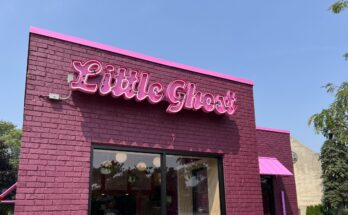 A photo of the exterior of Little Ghost, a pink building.