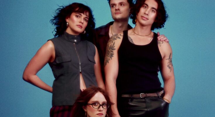 The Happy Fits posing in front of a blue background.