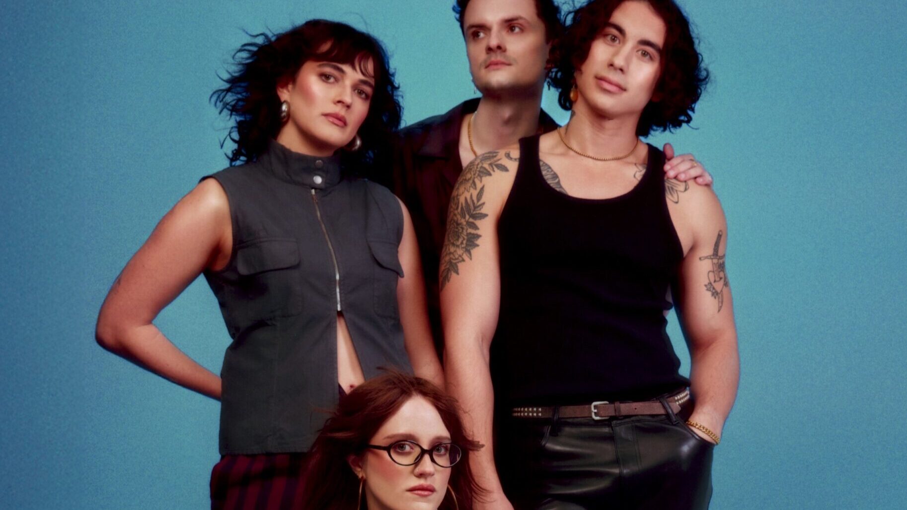 The Happy Fits posing in front of a blue background.