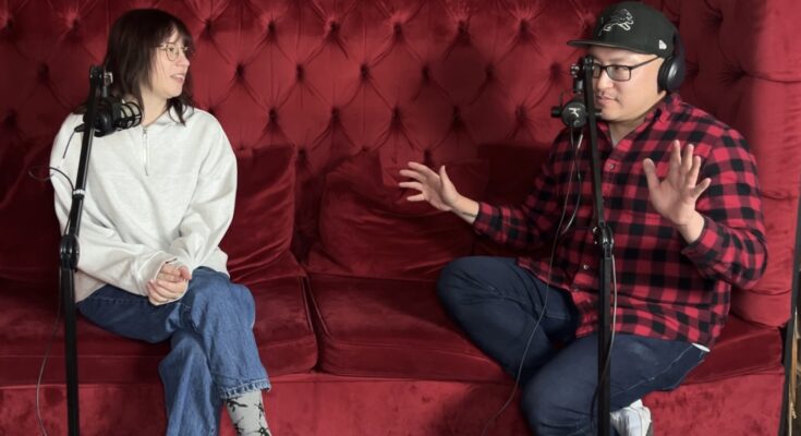 Shortly's Alex Maniak and Ferndale Radio's Dave Kim sit on a red couch during an interview.