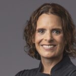 Chef Amber Poupore wearing a black shirt in a headshot.